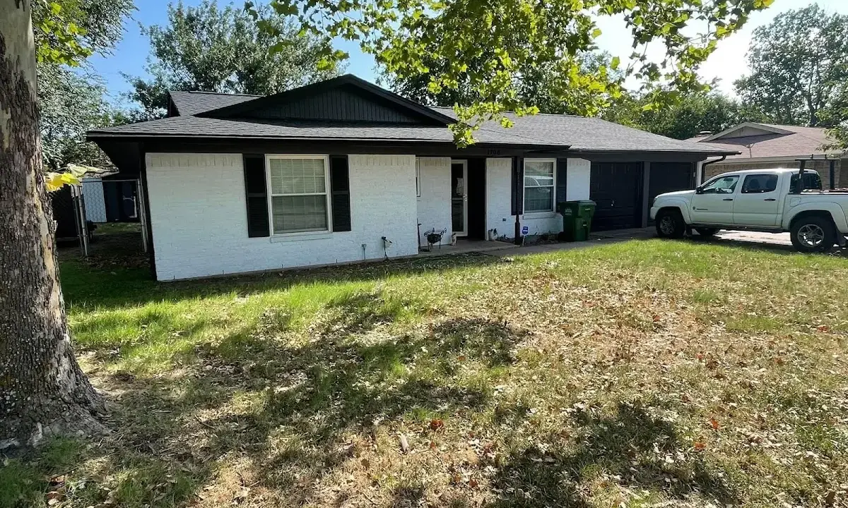 Professional roofing crew working on a residential roof in Parkland